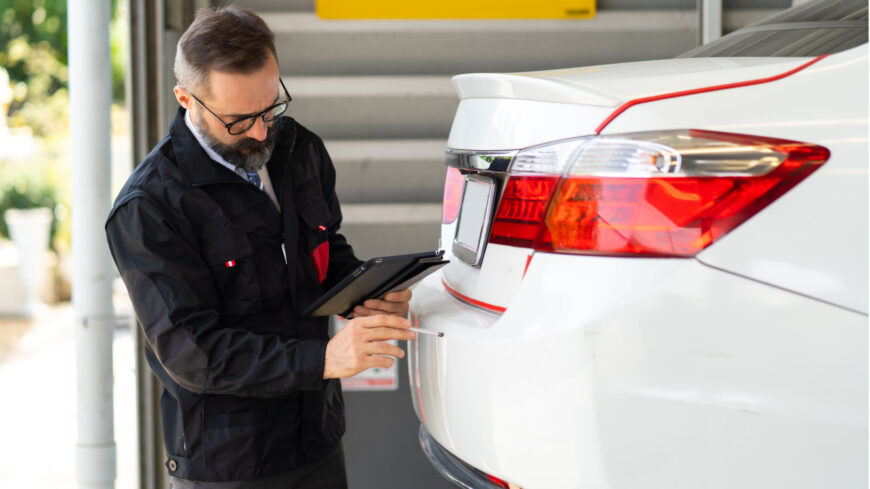 Technician Inspecting a car after the collision repairs have been completed.